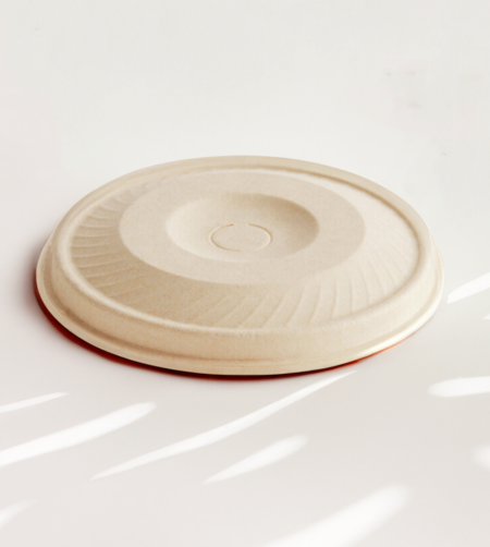 Compostable cup lid with straw hole made from upcycled hemp fiber, ideal for cold drinks.