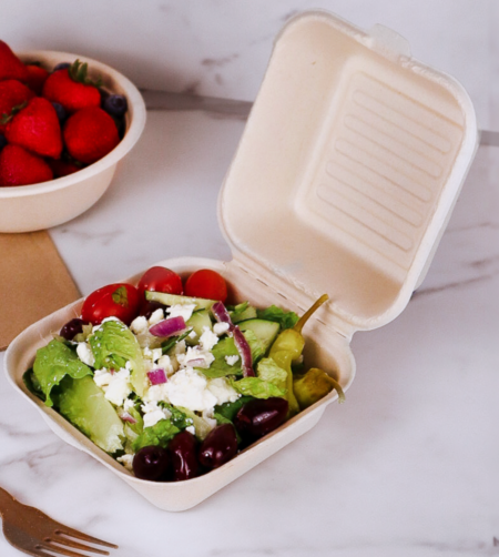 Compostable 450ml clamshell burger box filled with a greek salad, made from upcycled hemp fiber for sustainable food packaging.